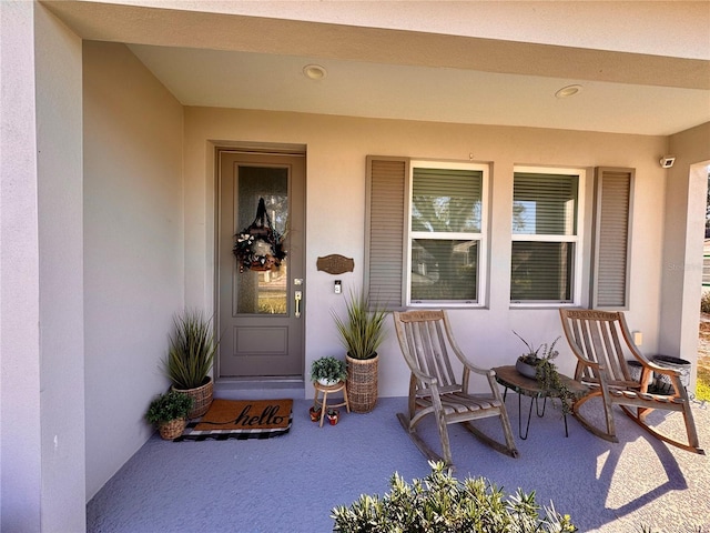 entrance to property with stucco siding