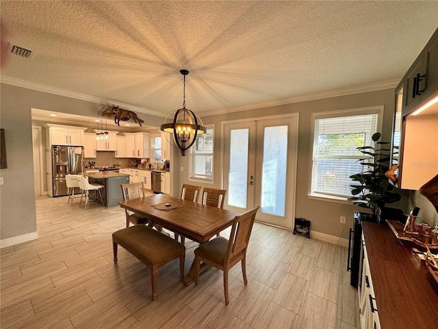 dining room featuring a textured ceiling, french doors, wood finish floors, and crown molding