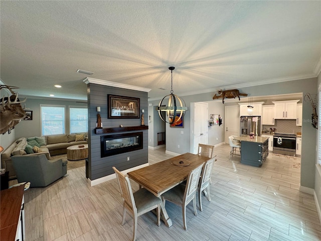 dining space featuring baseboards, visible vents, a glass covered fireplace, a textured ceiling, and crown molding