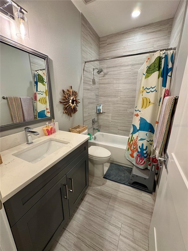 bathroom featuring toilet, shower / bath combination with curtain, and vanity