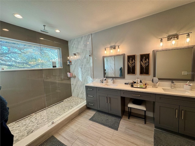 full bath featuring double vanity, a sink, and a walk in shower