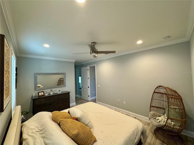 bedroom with baseboards, crown molding, and wood finished floors