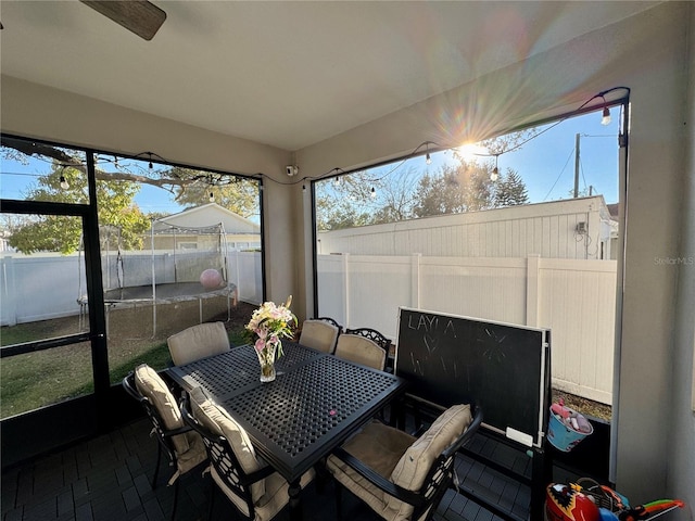 sunroom with a ceiling fan