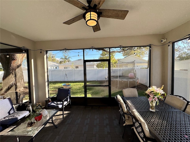 sunroom featuring ceiling fan