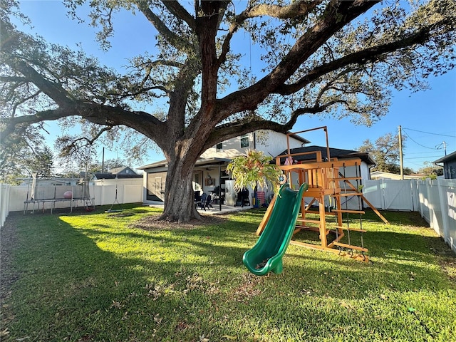 view of play area with a fenced backyard and a lawn