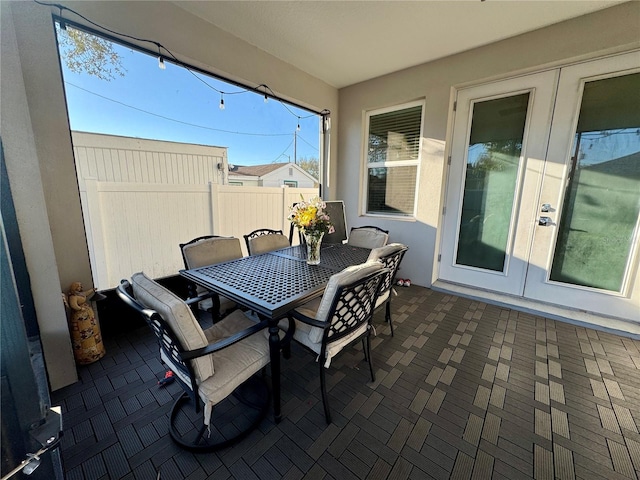 view of patio / terrace with outdoor dining space, fence, and french doors