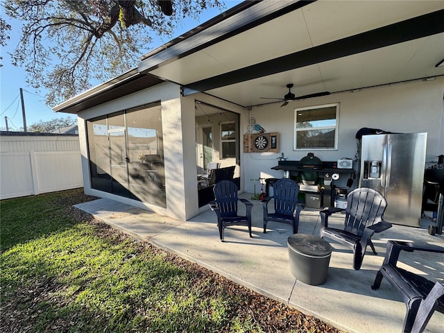 view of patio / terrace featuring ceiling fan and fence