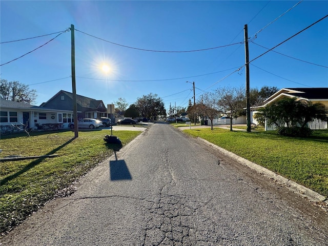 view of street with a residential view and curbs