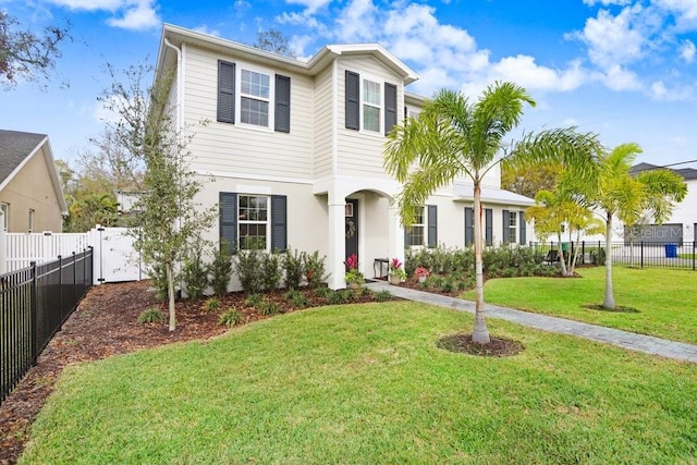 traditional-style home with a front yard and fence