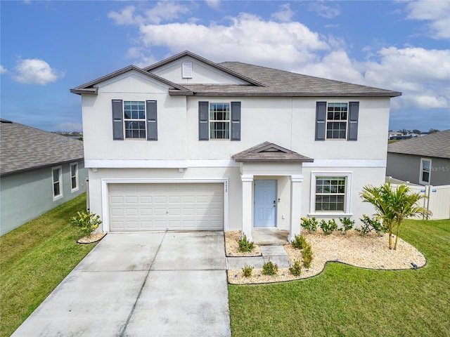 traditional-style home featuring a garage, a front yard, driveway, and stucco siding