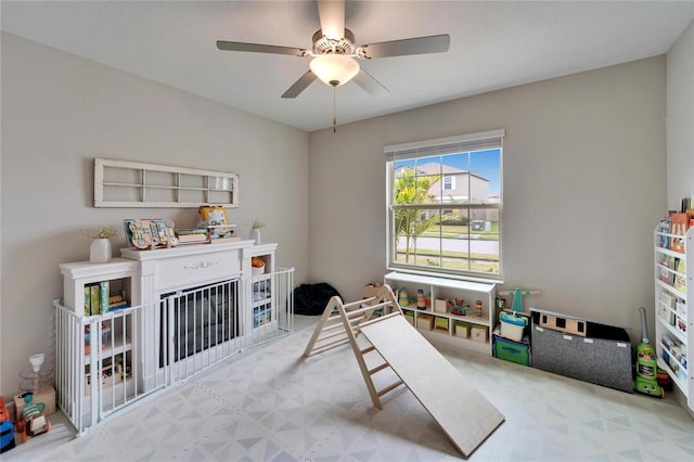 game room featuring a ceiling fan and tile patterned floors