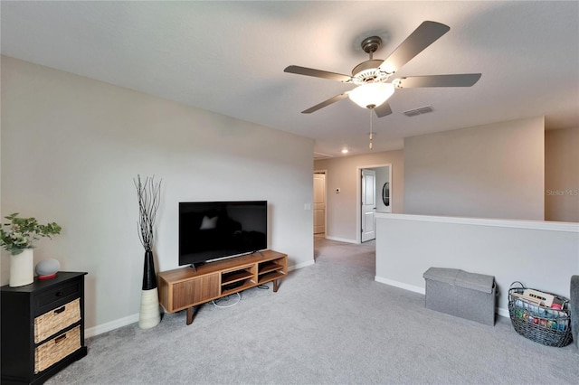 carpeted living room with ceiling fan, visible vents, and baseboards