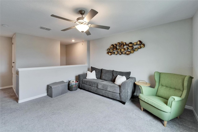 living room featuring carpet floors, baseboards, visible vents, and ceiling fan