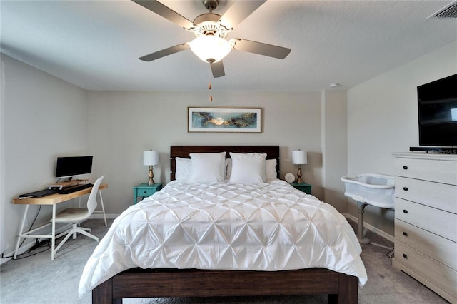 bedroom with light carpet, ceiling fan, visible vents, and baseboards