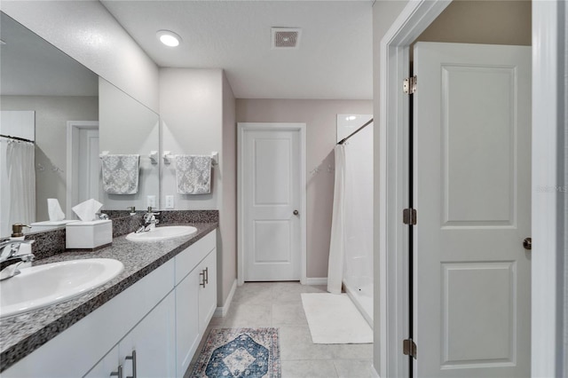 full bath with a shower stall, visible vents, a sink, and tile patterned floors