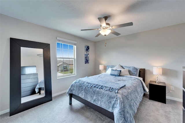 carpeted bedroom featuring ceiling fan, baseboards, and a textured ceiling