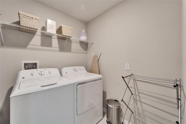 clothes washing area featuring laundry area and washing machine and clothes dryer