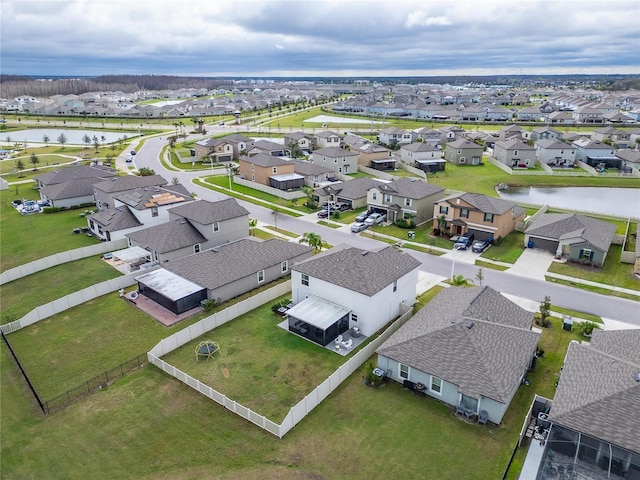 bird's eye view featuring a water view and a residential view