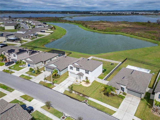 birds eye view of property featuring a water view and a residential view