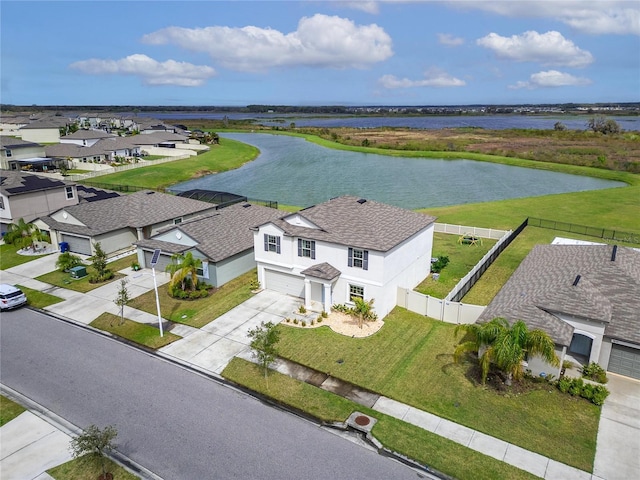 drone / aerial view with a water view and a residential view