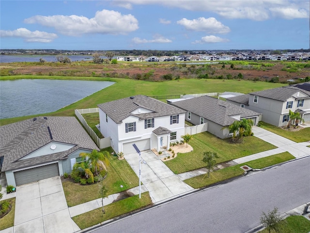 drone / aerial view with a water view and a residential view