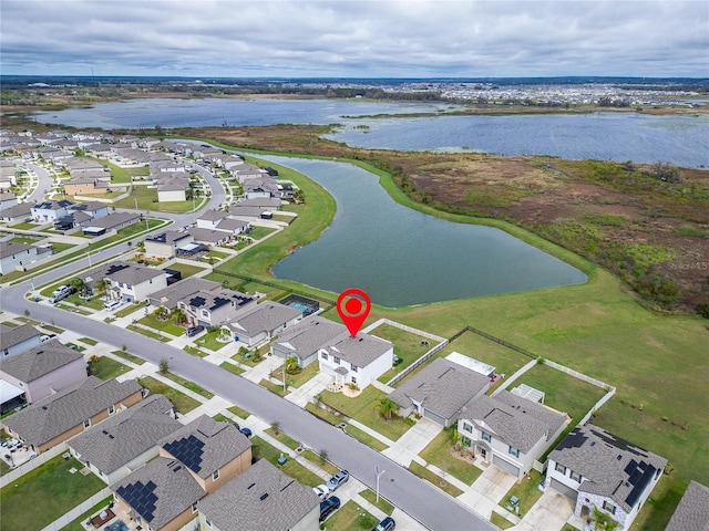 drone / aerial view featuring a water view and a residential view