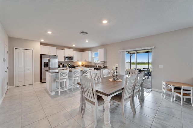 dining space with light tile patterned floors, baseboards, visible vents, and recessed lighting