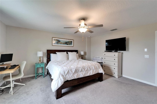 bedroom featuring baseboards, ceiling fan, visible vents, and light colored carpet