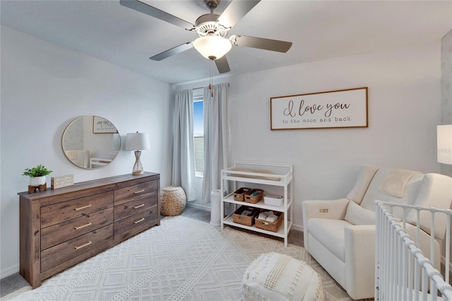 bedroom featuring a ceiling fan, light colored carpet, and baseboards