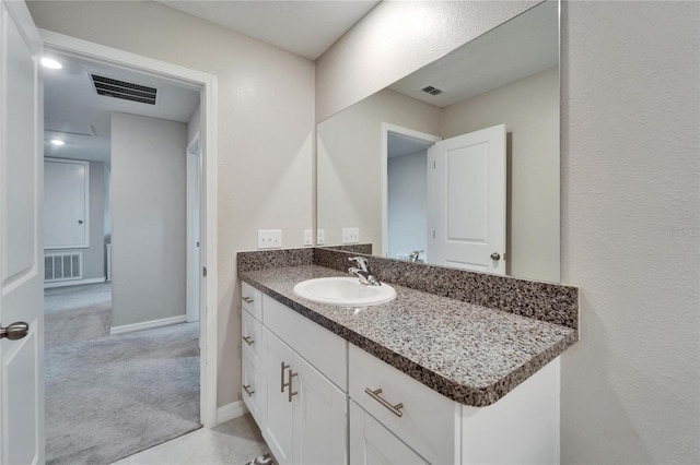 bathroom with baseboards, visible vents, and vanity