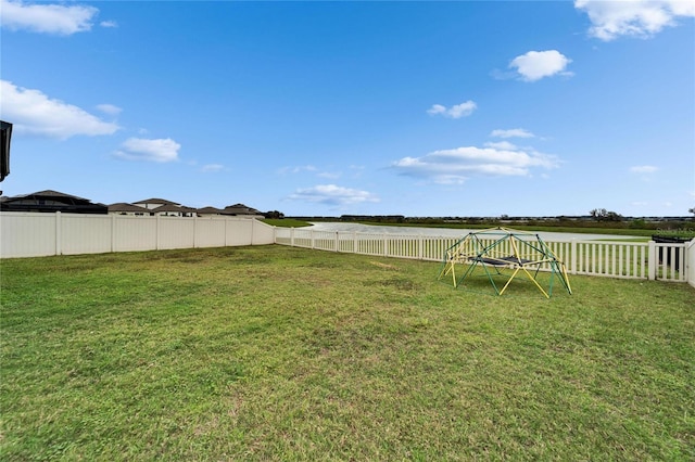 view of yard with a playground and a fenced backyard