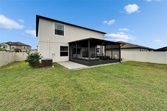 rear view of property with a yard, a fenced backyard, cooling unit, and a sunroom