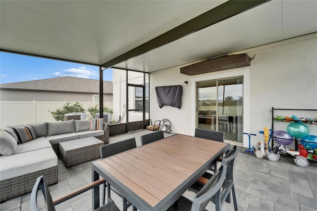 view of patio with an outdoor hangout area, outdoor dining space, and fence