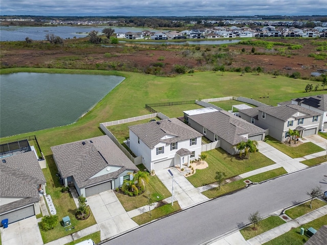 bird's eye view featuring a water view and a residential view