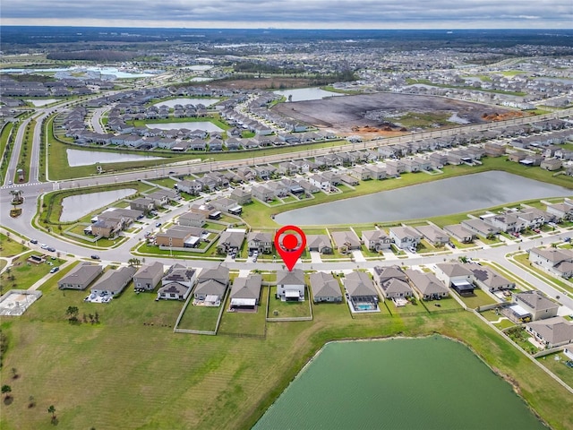 birds eye view of property with a water view and a residential view