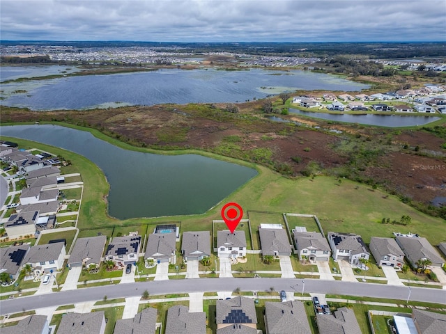 bird's eye view with a water view and a residential view