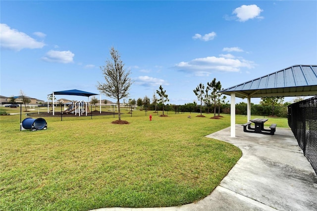 view of yard with a gazebo, playground community, a patio area, and fence