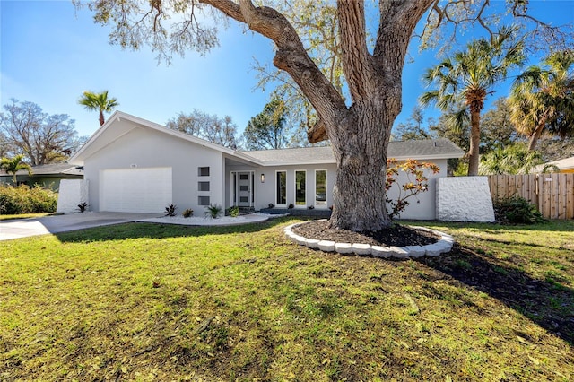 ranch-style house featuring a garage, driveway, fence, a front lawn, and stucco siding