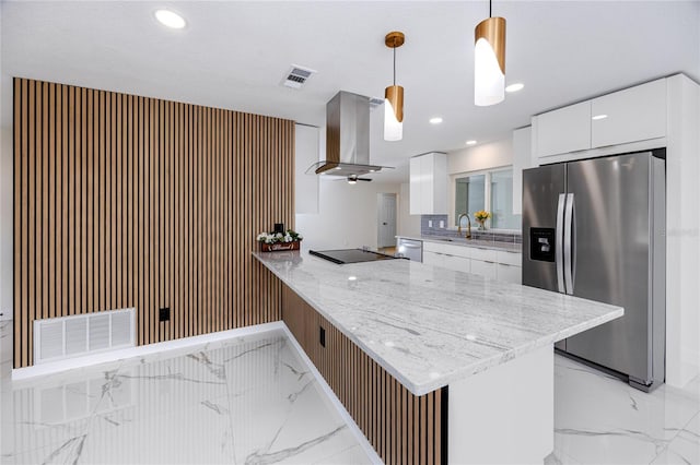 kitchen with white cabinets, a peninsula, hanging light fixtures, stainless steel appliances, and exhaust hood