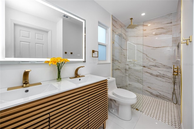 full bath with a marble finish shower, a sink, toilet, and double vanity