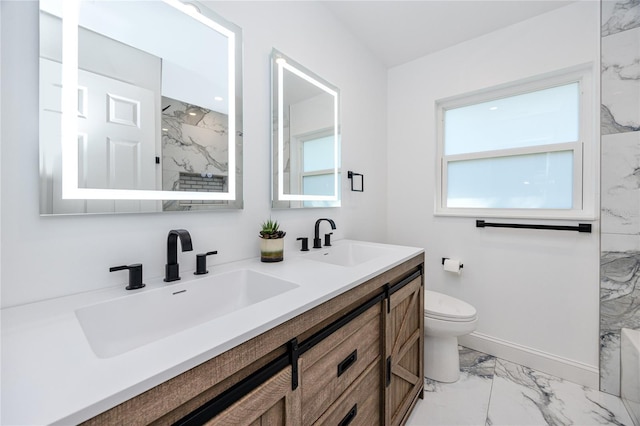 full bathroom featuring marble finish floor, double vanity, a sink, and toilet