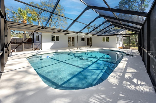 pool with a patio area, a lanai, and fence