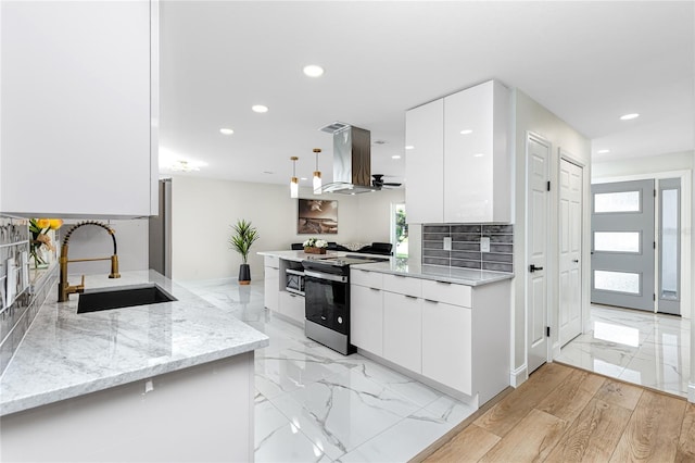 1100 Webb Dr, Clearwater, FL 33755 - kitchen with stainless steel electric range, island exhaust hood, modern cabinets, light marble finish floors, and recessed lighting