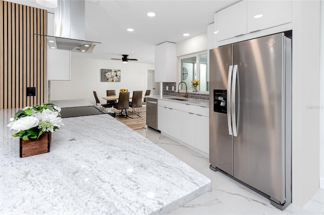 1100 Webb Dr, Clearwater, FL 33755 - kitchen featuring stainless steel appliances, modern cabinets, wall chimney range hood, white cabinetry, and recessed lighting