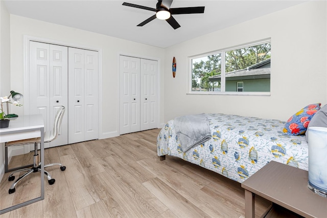 1100 Webb Dr, Clearwater, FL 33755 - bedroom featuring two closets, wood finished floors, a desk, and ceiling fan