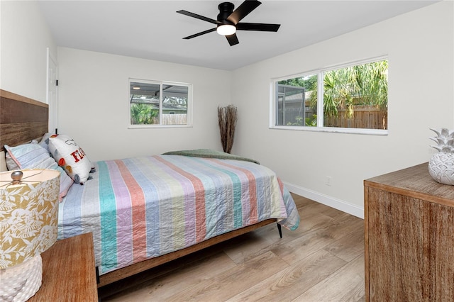 1100 Webb Dr, Clearwater, FL 33755 - bedroom with wood finished floors, multiple windows, and ceiling fan