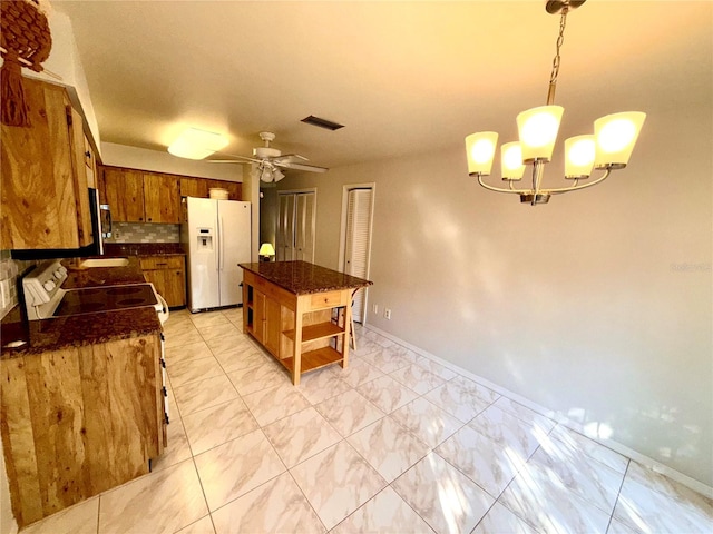 kitchen with electric range, white refrigerator with ice dispenser, visible vents, open shelves, and pendant lighting