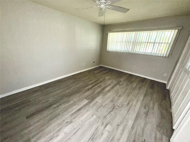 spare room with ceiling fan, baseboards, and wood finished floors