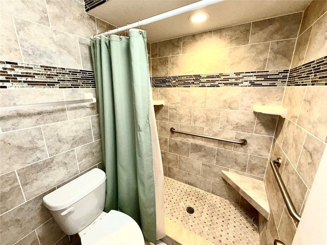 full bath with a stall shower and toilet