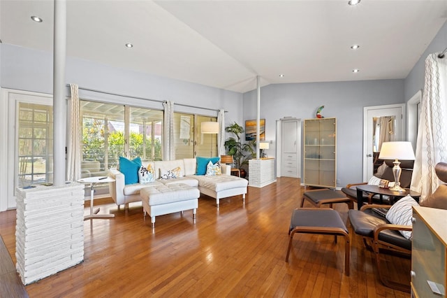 living area with lofted ceiling, hardwood / wood-style floors, and recessed lighting